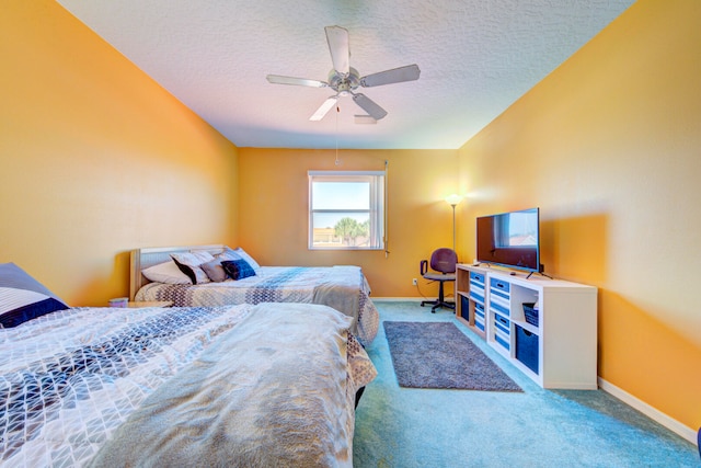 carpeted bedroom with a textured ceiling and ceiling fan