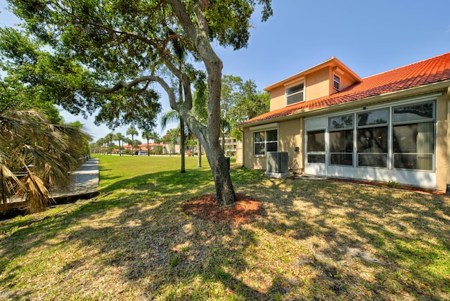 view of green lawn with central air condition unit