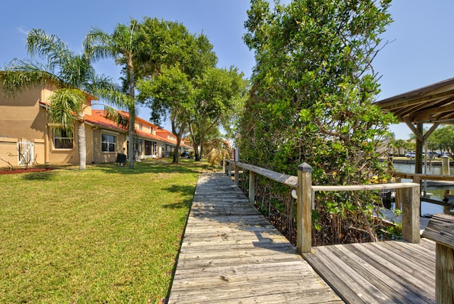 dock area featuring a yard and a water view