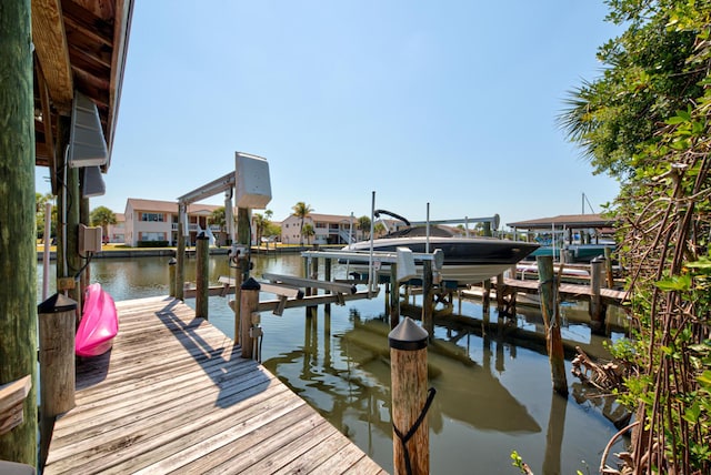 dock featuring boat lift and a water view