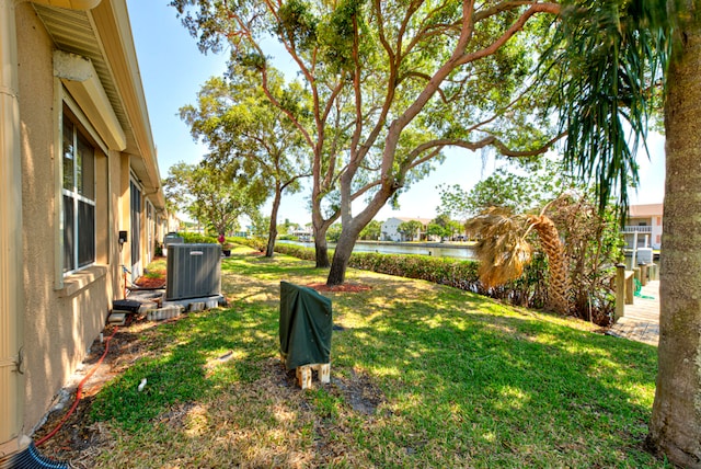 view of yard with a water view and cooling unit