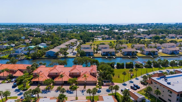 aerial view of residential area featuring a large body of water