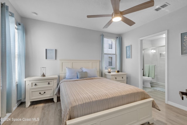 bedroom with connected bathroom, light hardwood / wood-style floors, and ceiling fan