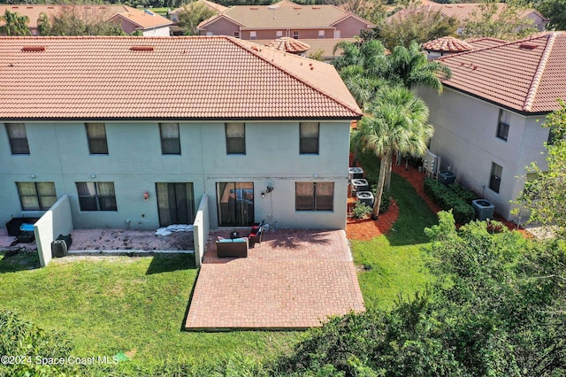 rear view of house with a patio area and a yard