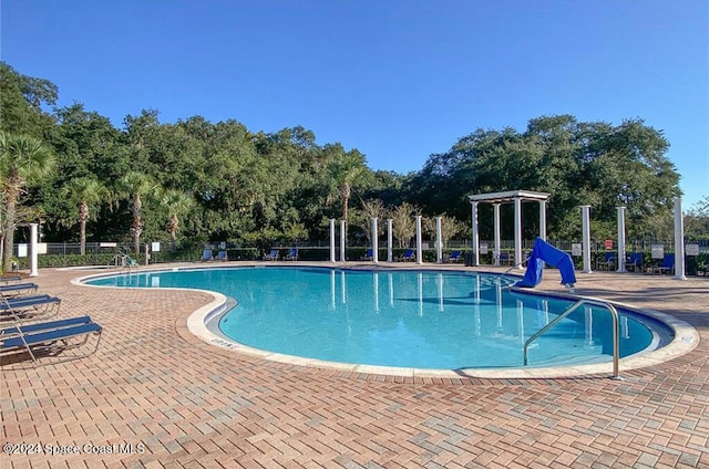 view of swimming pool with a pergola and a patio area