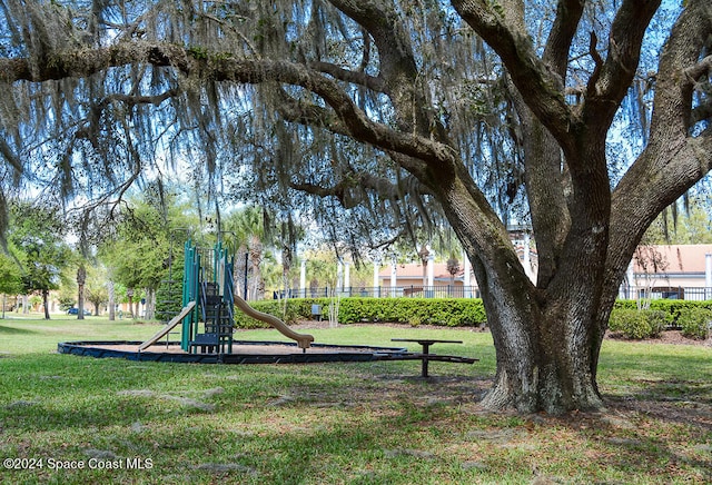 view of community with a playground and a yard