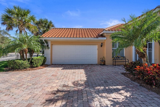 mediterranean / spanish-style house featuring a garage