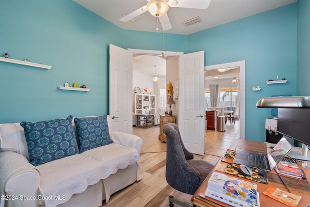 home office with ceiling fan and light hardwood / wood-style floors