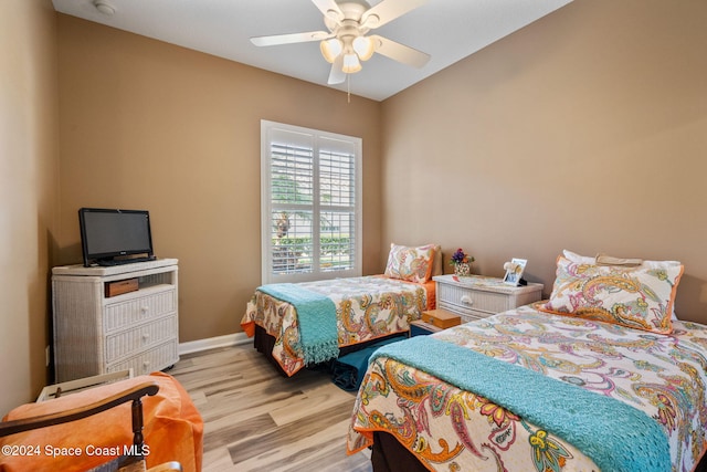 bedroom with ceiling fan and light hardwood / wood-style flooring