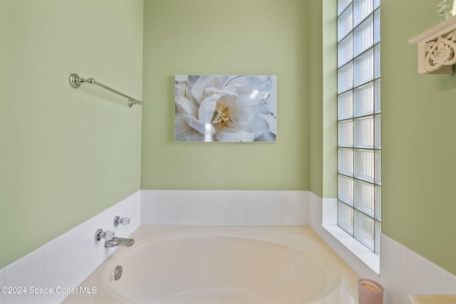 bathroom featuring a tub and plenty of natural light