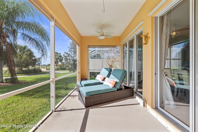 sunroom / solarium featuring ceiling fan