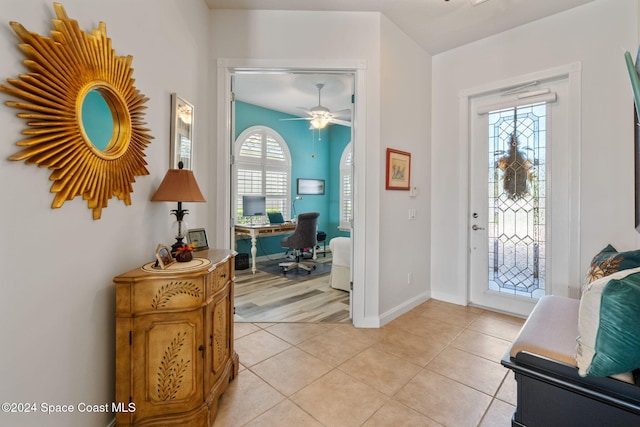 tiled foyer with ceiling fan