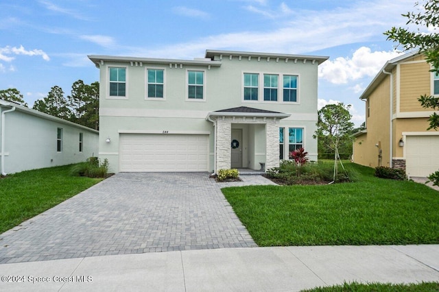 view of front of house featuring a front yard and a garage