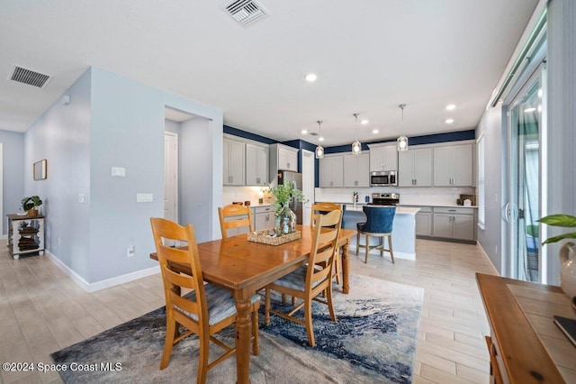 dining space with light hardwood / wood-style flooring