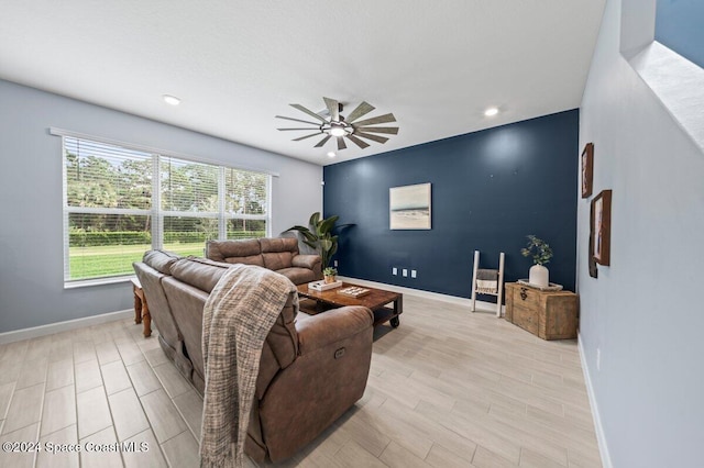 living room with light wood-type flooring and ceiling fan