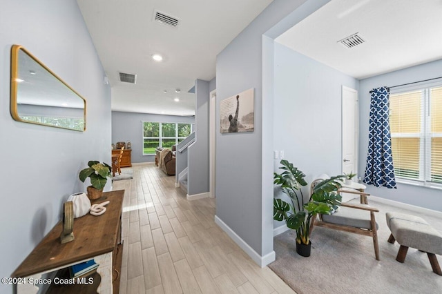 hallway with light hardwood / wood-style flooring