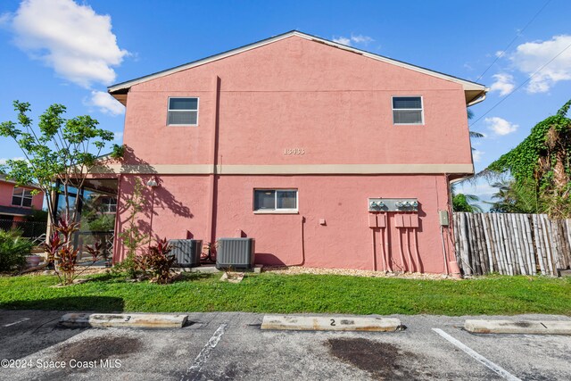 13433 Heald Ln Unit 1, Fort Myers, FL 33908 - view of side of property featuring uncovered parking and stucco siding