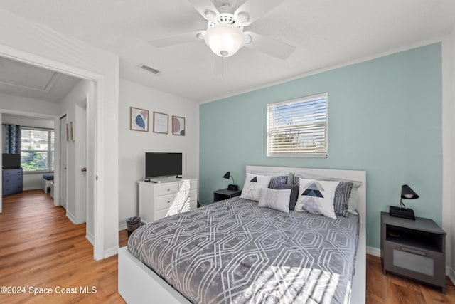13433 Heald Ln Unit 1, Fort Myers, FL 33908 - bedroom with wood finished floors, a ceiling fan, and attic access