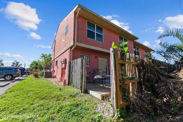 13433 Heald Ln Unit 1, Fort Myers, FL 33908 - view of property exterior featuring stucco siding and a deck