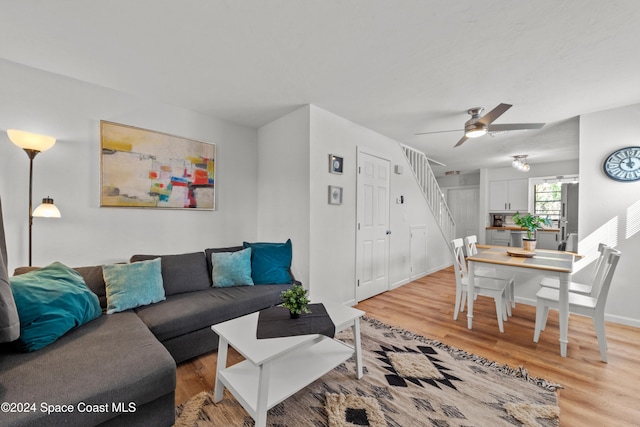 13433 Heald Ln Unit 1, Fort Myers, FL 33908 - living room featuring light wood-style floors, ceiling fan, and stairway