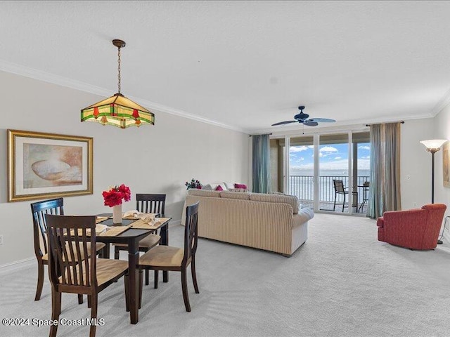 dining space with floor to ceiling windows, ceiling fan, carpet floors, and ornamental molding