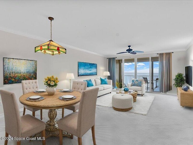 dining room with floor to ceiling windows, ceiling fan, carpet floors, and ornamental molding