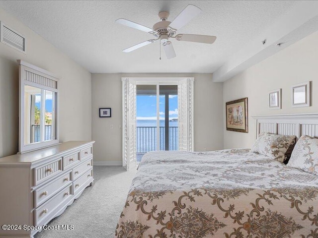 bedroom with light carpet, access to outside, multiple windows, and ceiling fan