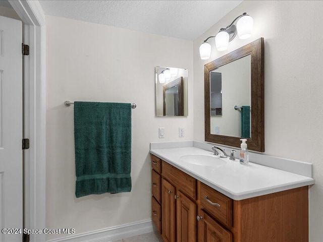 bathroom featuring vanity and a textured ceiling