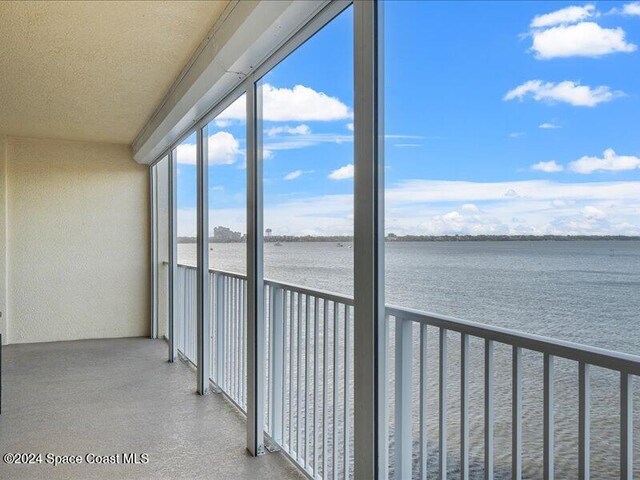 unfurnished sunroom with a water view