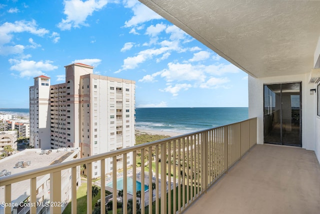 balcony with a beach view and a water view