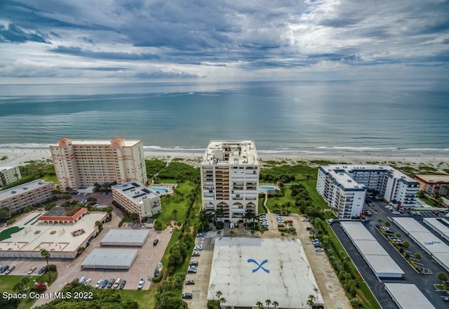 drone / aerial view with a water view and a beach view