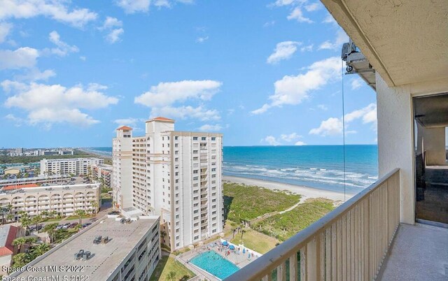 balcony with a water view and a beach view