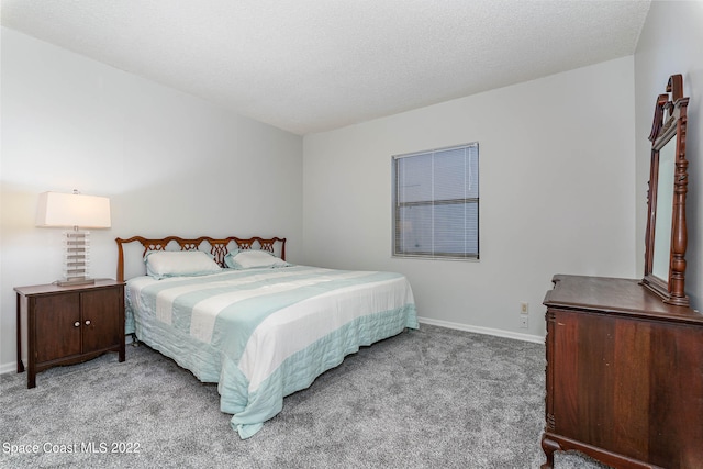 carpeted bedroom featuring a textured ceiling