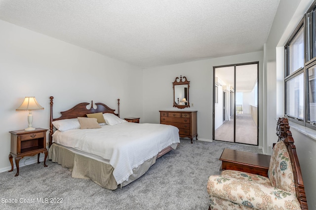 carpeted bedroom with a textured ceiling