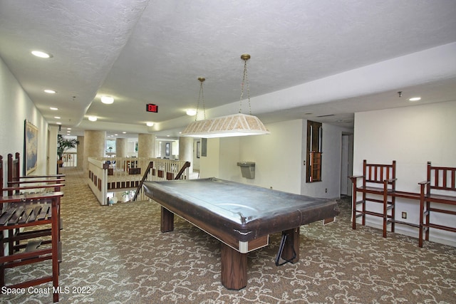 rec room featuring dark colored carpet, a textured ceiling, and billiards