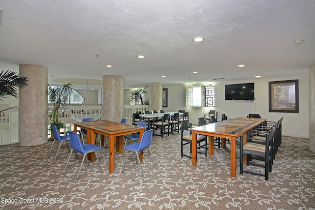 dining area featuring carpet floors and a textured ceiling