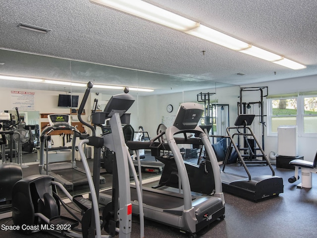 workout area with a textured ceiling