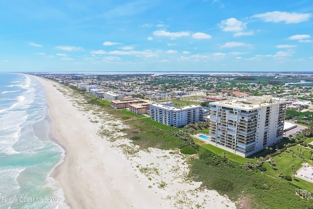 aerial view with a water view and a beach view