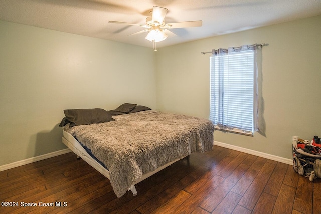 bedroom featuring ceiling fan and dark hardwood / wood-style floors