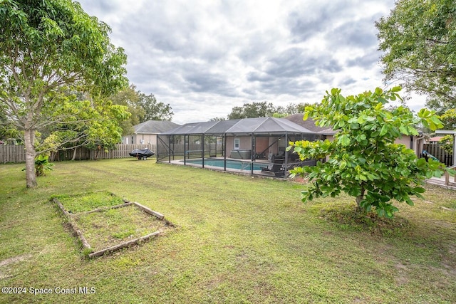 view of yard with a fenced in pool and a lanai