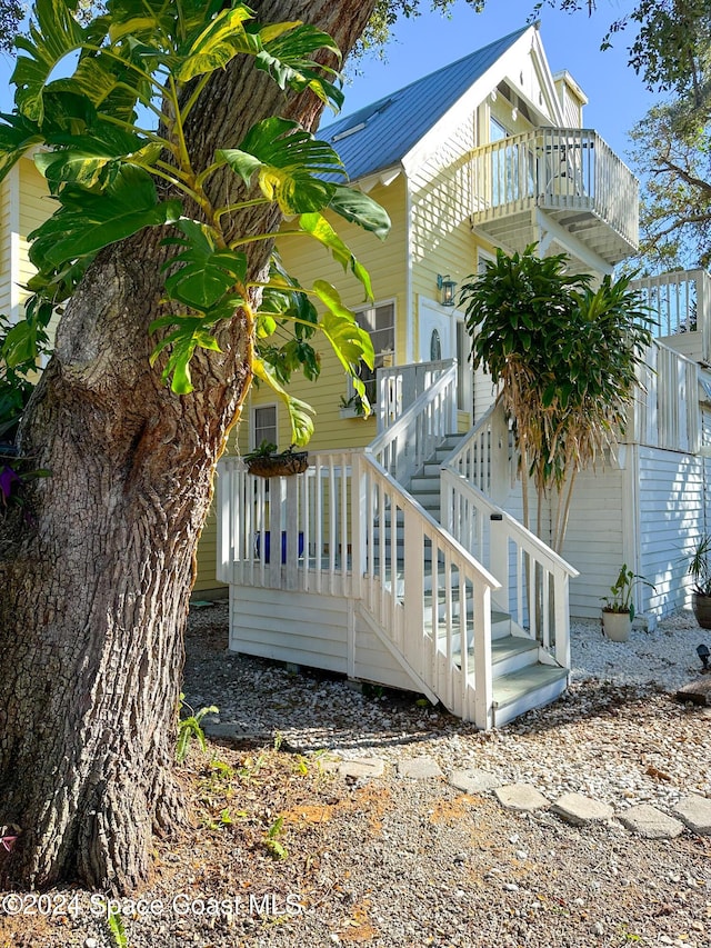 5875 Riverside Dr, Melbourne Beach, FL 32951 - view of side of property featuring a balcony