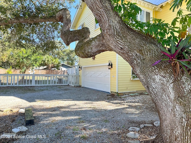 5875 Riverside Dr, Melbourne Beach, FL 32951 - view of side of home featuring gravel driveway