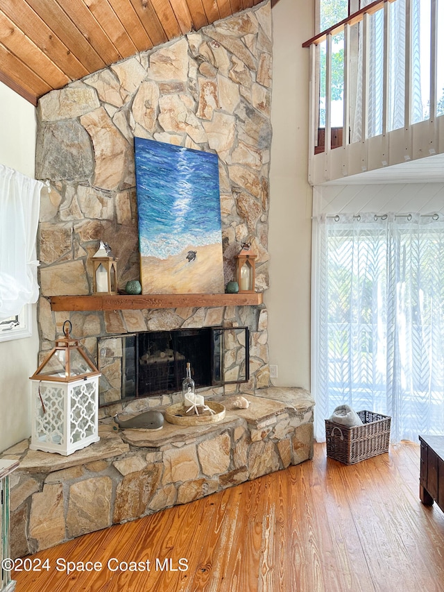 unfurnished living room with a healthy amount of sunlight, a fireplace, wood ceiling, and lofted ceiling