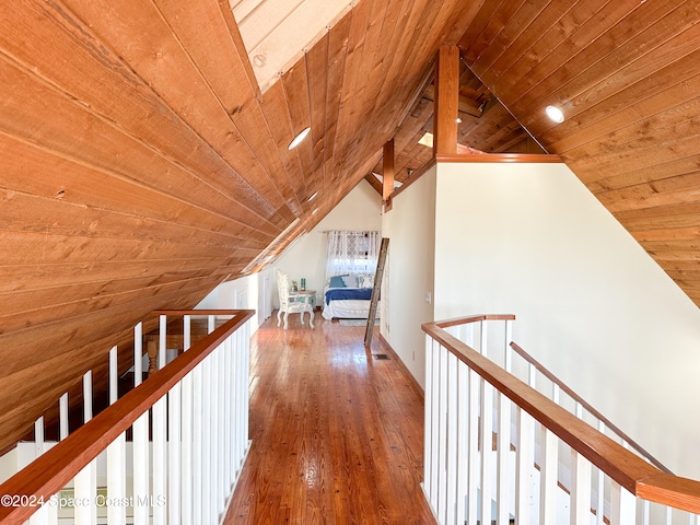 hall with hardwood / wood-style flooring, lofted ceiling, and wood ceiling