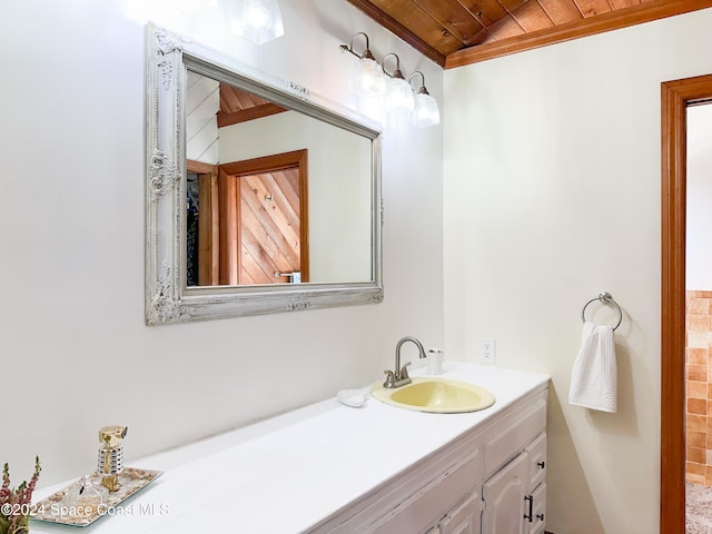 5875 Riverside Dr, Melbourne Beach, FL 32951 - bathroom with wood ceiling, vanity, and crown molding