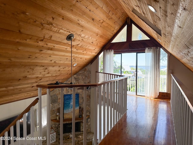 corridor featuring lofted ceiling, wood-type flooring, and wood ceiling