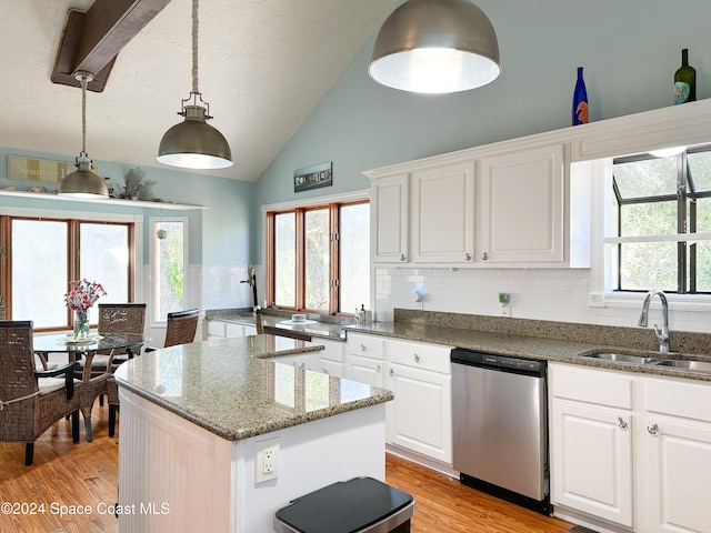 kitchen featuring stainless steel dishwasher, sink, pendant lighting, light hardwood / wood-style flooring, and white cabinets