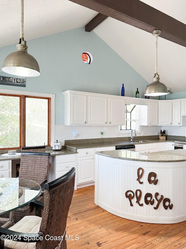 kitchen featuring lofted ceiling with beams, light wood-type flooring, white cabinetry, and hanging light fixtures