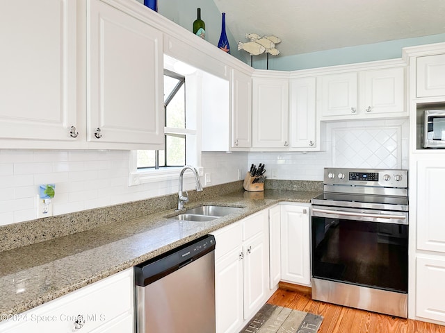 kitchen featuring light hardwood / wood-style floors, sink, white cabinetry, and stainless steel appliances