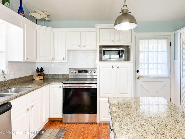 kitchen featuring sink, white cabinets, and appliances with stainless steel finishes